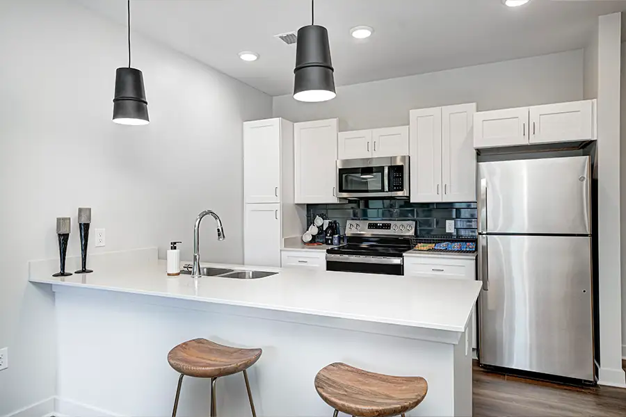 If you can't use your apartment kitchen like this East Banks Apartment one during a power outage, consider outdoor cooking options, order in, or stay with a friend. A modern apartment kitchen